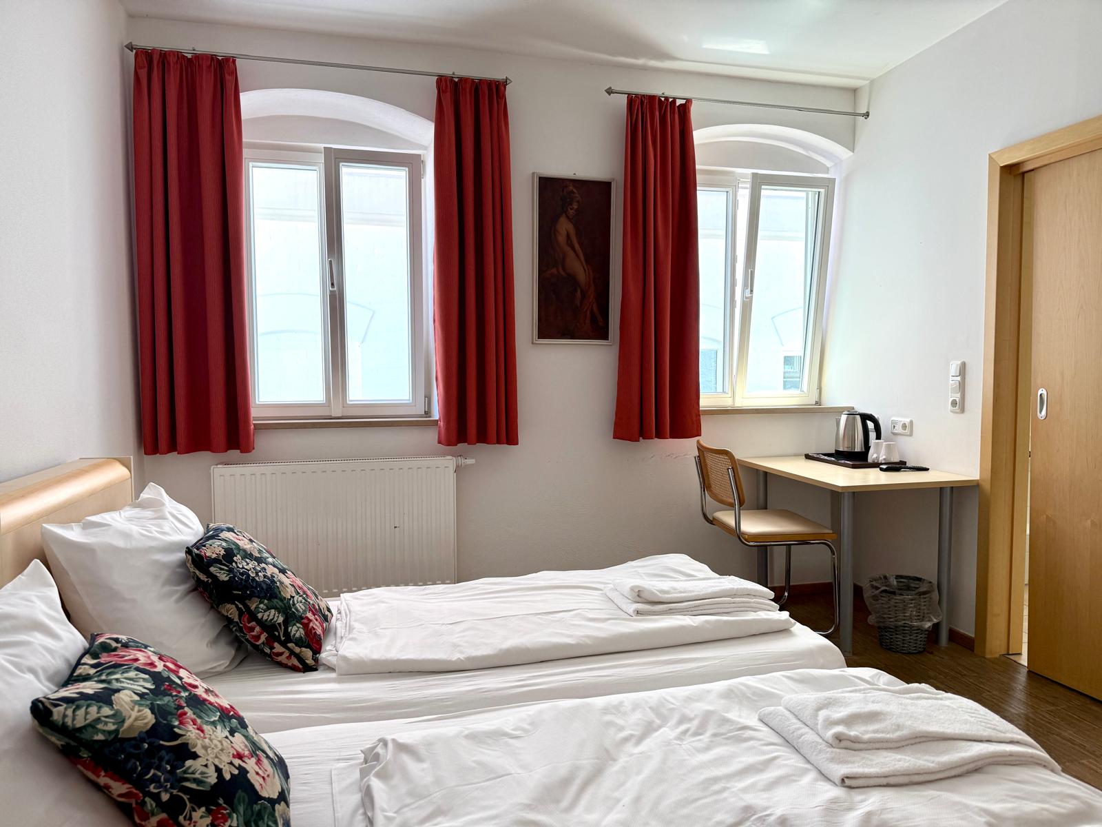 Spacious double room with large comfortable bed and modern furnishings at Hotel Stadtblick Friedberg