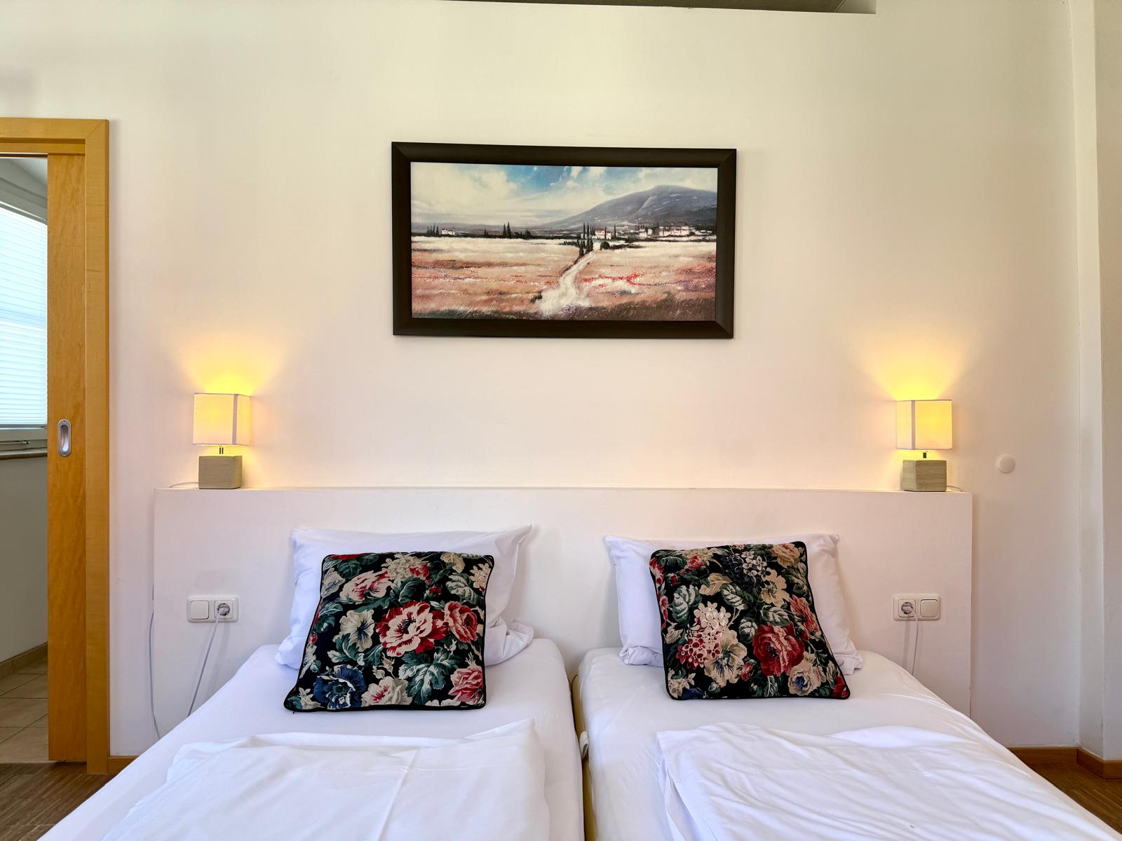 Spacious family suite bedroom with double bed at Hotel Stadtblick Friedberg