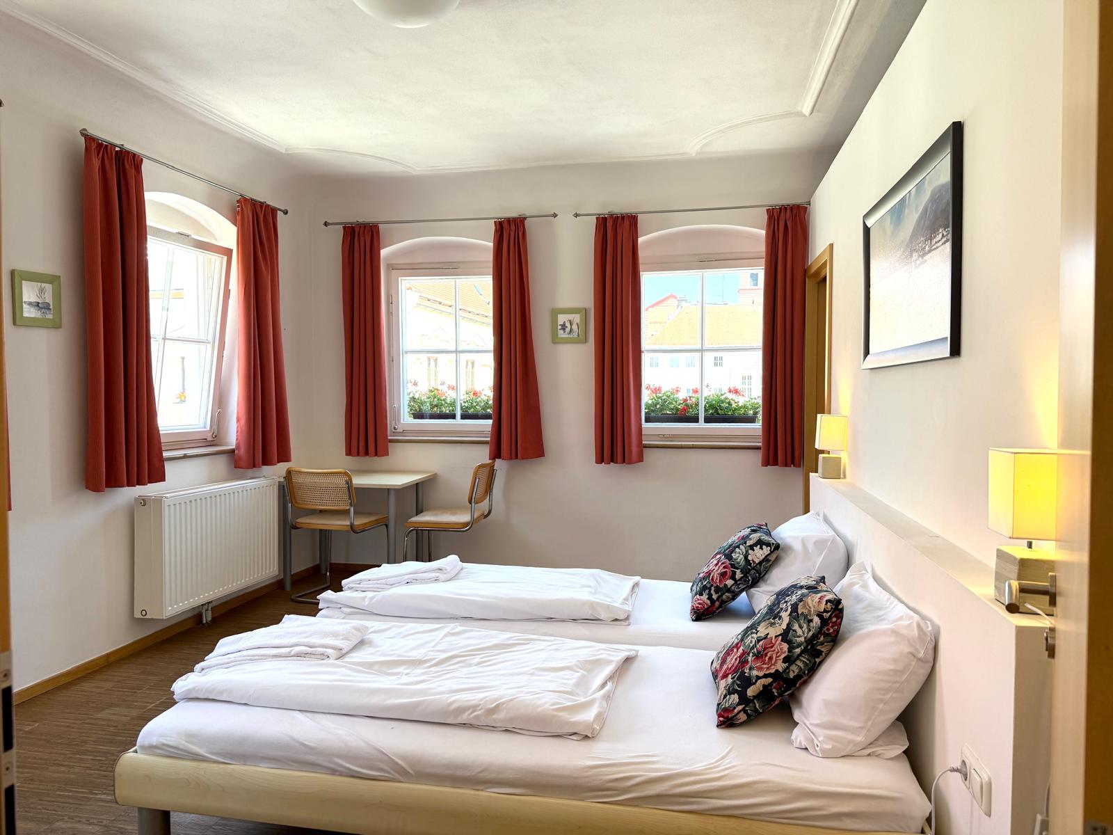 Spacious family suite bedroom with double bed at Hotel Stadtblick Friedberg