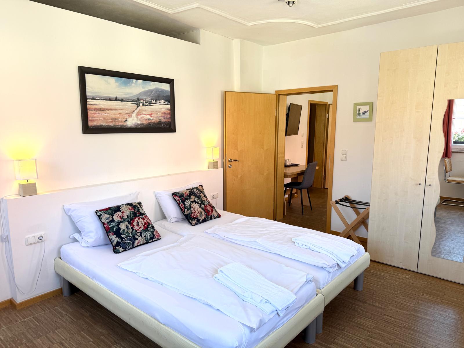 Spacious family suite bedroom with double bed at Hotel Stadtblick Friedberg