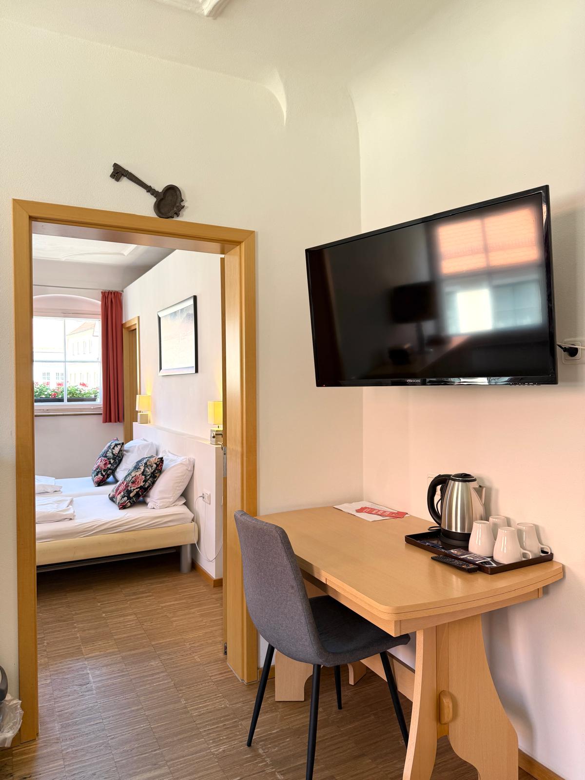 Spacious family suite bedroom with double bed at Hotel Stadtblick Friedberg